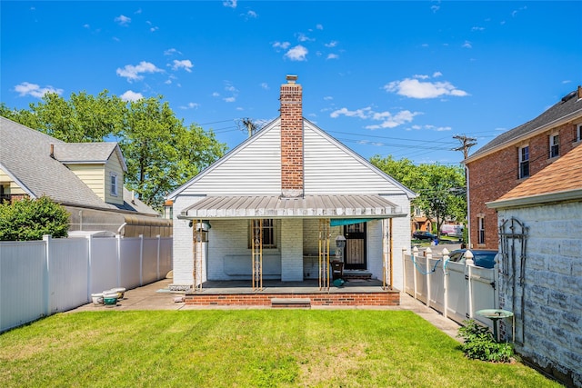 back of property with brick siding, a chimney, and covered porch