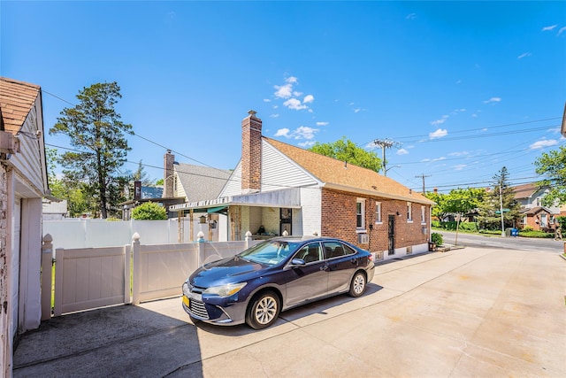 view of side of property featuring brick siding and a chimney