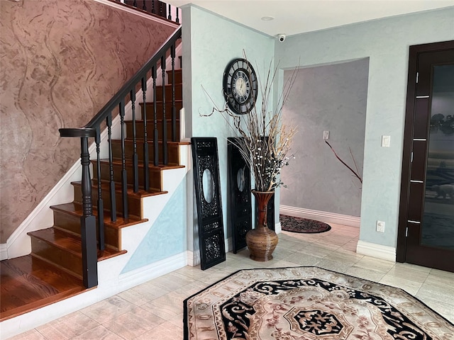 1010 S End, Woodmere, NY 11598 - foyer featuring baseboards, stairway, and tile patterned floors