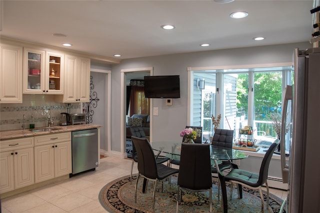 1010 S End, Woodmere, NY 11598 - kitchen featuring appliances with stainless steel finishes, a sink, recessed lighting, decorative backsplash, and light stone countertops