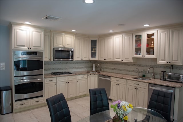 1010 S End, Woodmere, NY 11598 - kitchen with stainless steel appliances, a sink, backsplash, light stone countertops, and recessed lighting