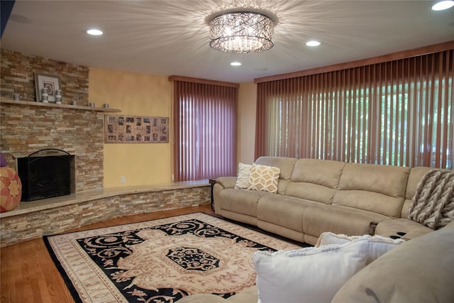 1010 S End, Woodmere, NY 11598 - living area featuring wood finished floors, recessed lighting, a stone fireplace, and a chandelier