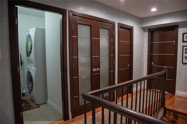 1010 S End, Woodmere, NY 11598 - hallway featuring stacked washing machine and dryer, an upstairs landing, baseboards, and recessed lighting