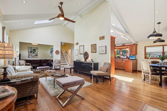 1 Meadowood Path, New Rochelle, NY 10804 - living room featuring a ceiling fan, stairway, beamed ceiling, high vaulted ceiling, and light wood-type flooring