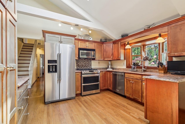 1 Meadowood Path, New Rochelle, NY 10804 - kitchen with appliances with stainless steel finishes, vaulted ceiling, light wood-type flooring, a sink, and light stone counters