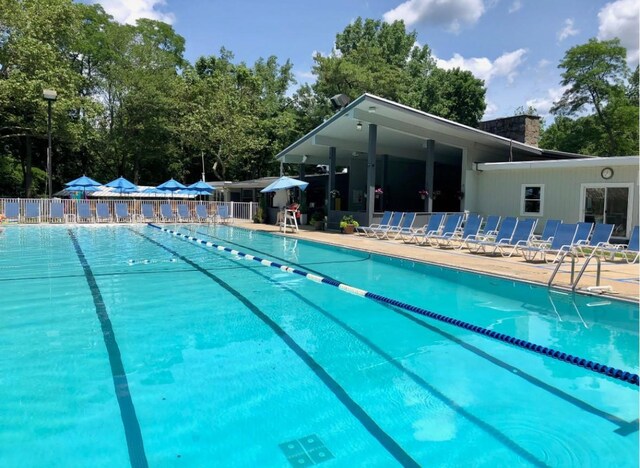 1 Meadowood Path, New Rochelle, NY 10804 - community pool with view of scattered trees and a patio