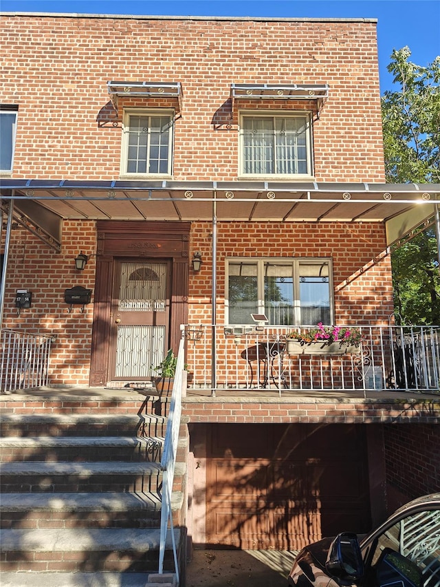 17-12 Starr St, Ridgewood, NY 11385 - view of front facade with brick siding and covered porch