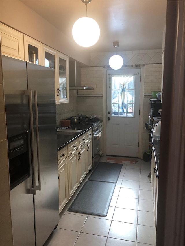 17-12 Starr St, Ridgewood, NY 11385 - kitchen with stainless steel appliances, wall chimney range hood, light tile patterned floors, dark countertops, and tile walls