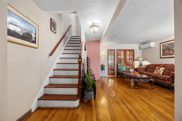 17-12 Starr St, Ridgewood, NY 11385 - stairway featuring a wall mounted air conditioner, hardwood / wood-style flooring, and baseboards