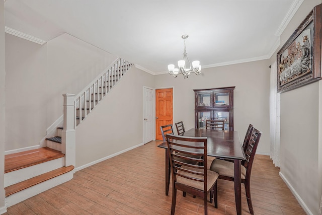 70-27 69th St, Glendale, NY 11385 - dining area with a chandelier, stairs, crown molding, wood finished floors, and baseboards