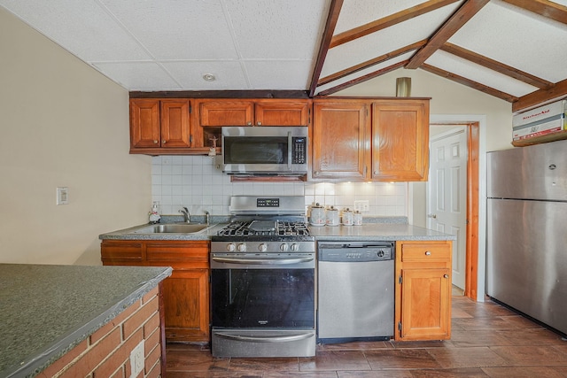 70-27 69th St, Glendale, NY 11385 - kitchen with stainless steel appliances, a sink, backsplash, brown cabinets, and lofted ceiling