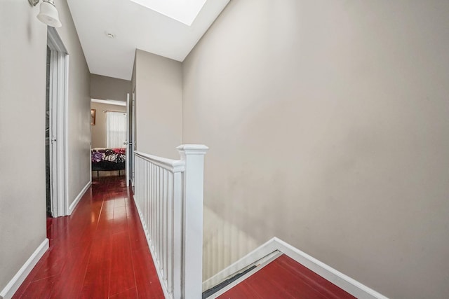 70-27 69th St, Glendale, NY 11385 - corridor featuring an upstairs landing, a skylight, wood finished floors, and baseboards