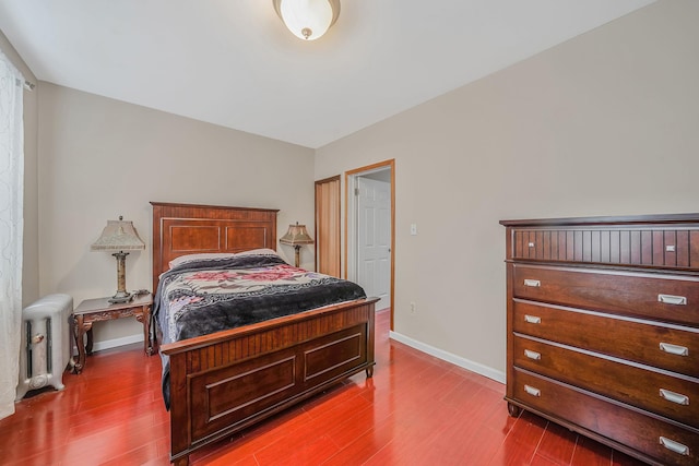 70-27 69th St, Glendale, NY 11385 - bedroom with radiator heating unit, wood finished floors, and baseboards