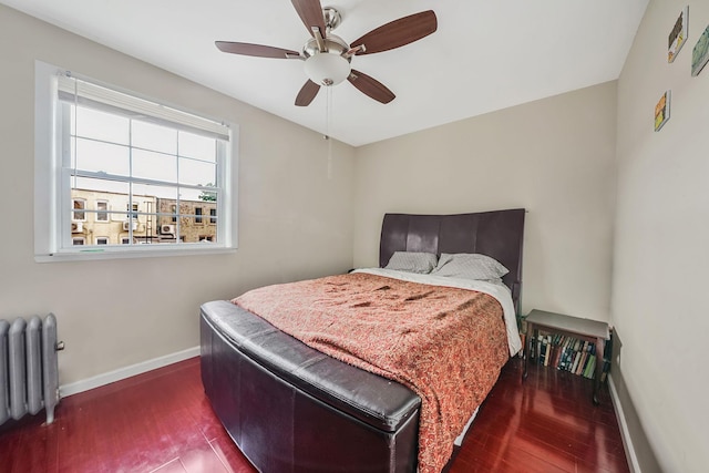 70-27 69th St, Glendale, NY 11385 - bedroom featuring radiator, hardwood / wood-style floors, baseboards, and ceiling fan