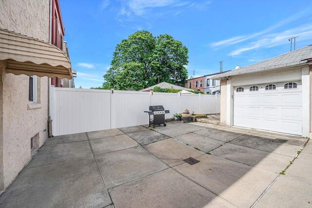 70-27 69th St, Glendale, NY 11385 - view of patio / terrace with area for grilling, a garage, and concrete driveway