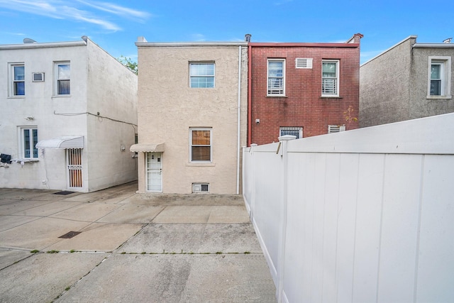 70-27 69th St, Glendale, NY 11385 - rear view of house featuring a patio and stucco siding