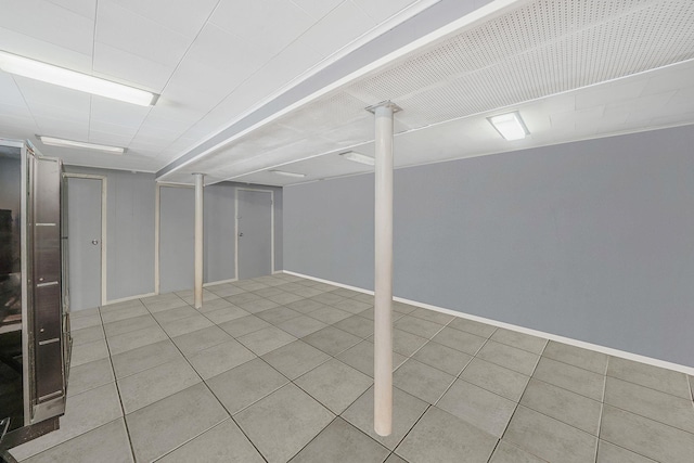 70-27 69th St, Glendale, NY 11385 - finished below grade area featuring tile patterned floors and baseboards