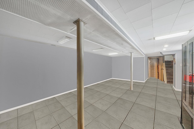 70-27 69th St, Glendale, NY 11385 - finished below grade area with tile patterned floors, baseboards, and stairs