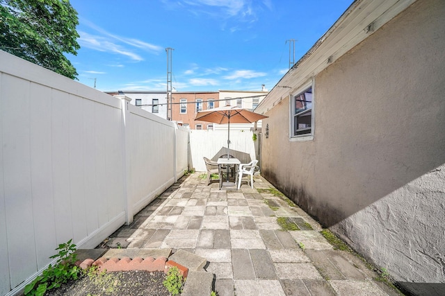 70-27 69th St, Glendale, NY 11385 - fenced backyard featuring outdoor dining space and a patio
