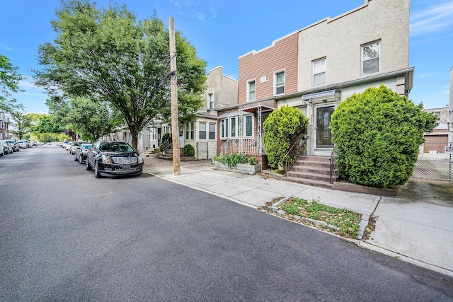 70-27 69th St, Glendale, NY 11385 - view of front facade with stucco siding and a residential view
