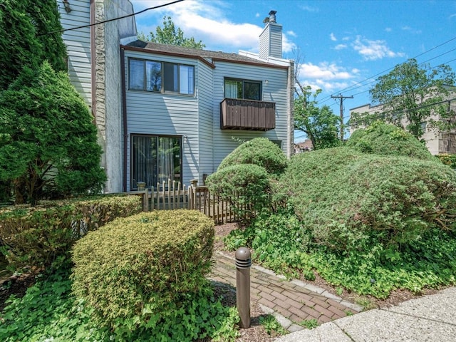 10 Wooleys Ln Unit 1F, Great Neck, NY 11023 - rear view of property featuring a chimney