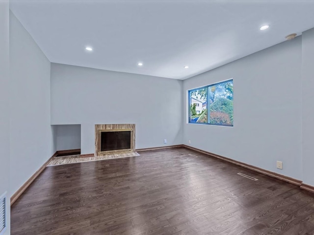 10 Wooleys Ln Unit 1F, Great Neck, NY 11023 - unfurnished living room featuring wood finished floors, baseboards, recessed lighting, and a fireplace with flush hearth