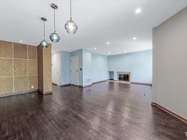 10 Wooleys Ln Unit 1F, Great Neck, NY 11023 - unfurnished living room featuring dark wood-type flooring, baseboards, a glass covered fireplace, and recessed lighting