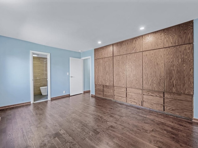 10 Wooleys Ln Unit 1F, Great Neck, NY 11023 - unfurnished bedroom featuring dark wood-type flooring, baseboards, recessed lighting, and ensuite bathroom