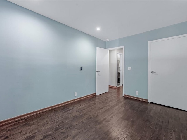 10 Wooleys Ln Unit 1F, Great Neck, NY 11023 - unfurnished bedroom with dark wood finished floors, recessed lighting, and baseboards
