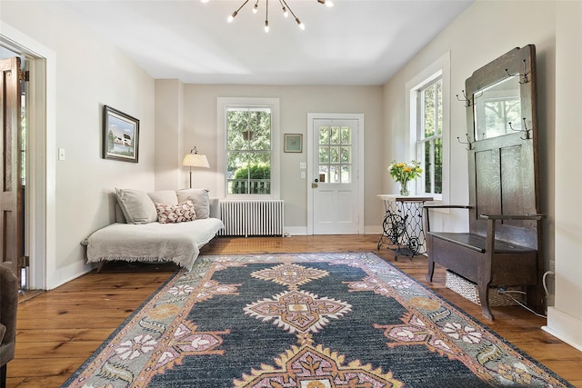 679 Titicus Rd, North Salem, NY 10560 - foyer entrance featuring radiator heating unit, wood finished floors, and a chandelier