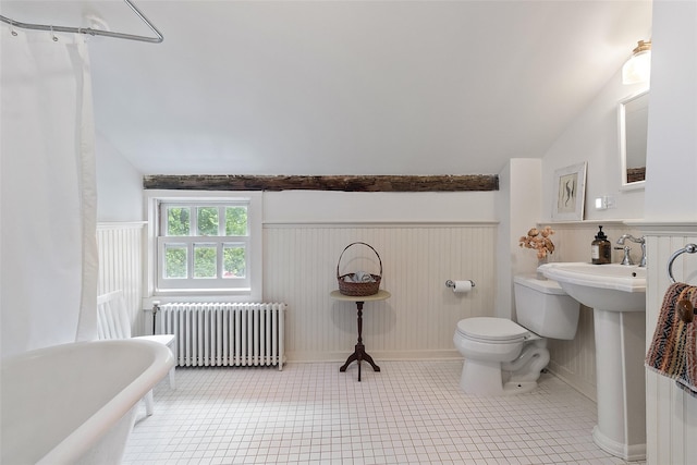 679 Titicus Rd, North Salem, NY 10560 - bathroom with radiator heating unit, a freestanding bath, toilet, vaulted ceiling, and a wainscoted wall