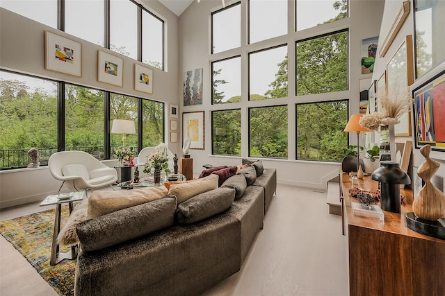 7 Robin Ln, Shelter Island Heights, NY 11964 - living room with baseboards, a high ceiling, and wood finished floors