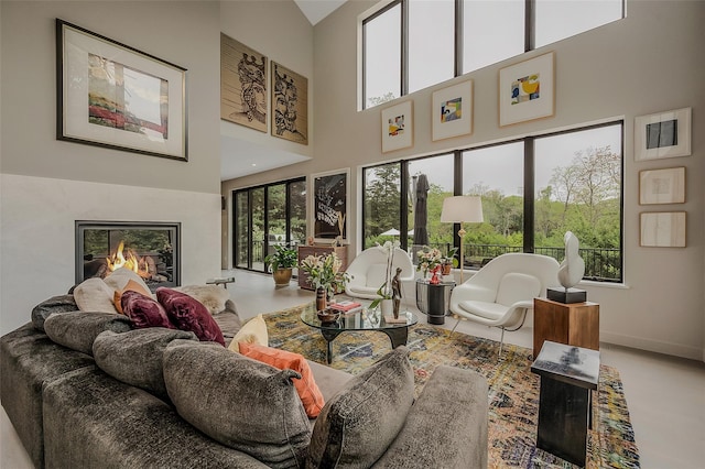 7 Robin Ln, Shelter Island Heights, NY 11964 - living area featuring a high ceiling, a high end fireplace, and baseboards