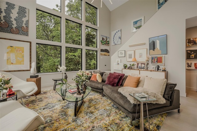 7 Robin Ln, Shelter Island Heights, NY 11964 - living area featuring high vaulted ceiling, baseboards, and wood finished floors