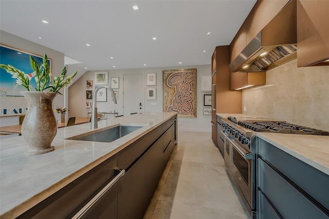7 Robin Ln, Shelter Island Heights, NY 11964 - kitchen featuring stainless steel stove, a sink, wall chimney exhaust hood, recessed lighting, and light stone counters