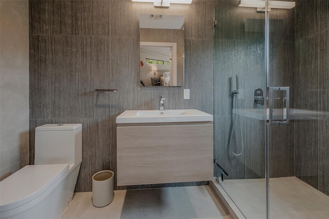 7 Robin Ln, Shelter Island Heights, NY 11964 - bathroom with toilet, a shower stall, vanity, and tile walls