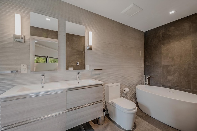 7 Robin Ln, Shelter Island Heights, NY 11964 - full bath featuring tile walls, tile patterned flooring, a freestanding bath, double vanity, and toilet