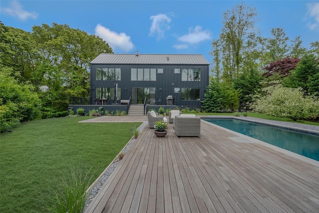 7 Robin Ln, Shelter Island Heights, NY 11964 - back of property featuring an outdoor pool, a yard, a patio, and board and batten siding
