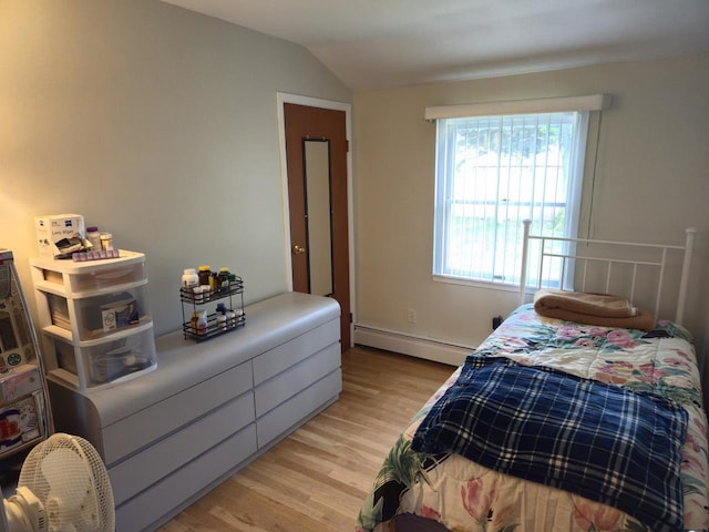 22 E Sycamore St, Central Islip, NY 11722 - bedroom with baseboard heating, light wood finished floors, and lofted ceiling