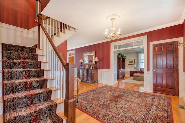 32 Old Chester Rd, Goshen, NY 10924 - entrance foyer featuring stairs, a chandelier, ornamental molding, wood finished floors, and wainscoting