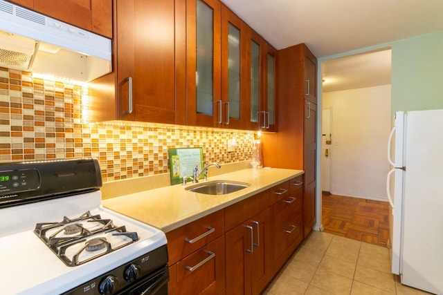 365 Bronx River Rd Unit 2M, Yonkers, NY 10704 - kitchen with white appliances, a sink, under cabinet range hood, light countertops, and decorative backsplash