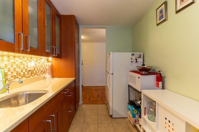 365 Bronx River Rd Unit 2M, Yonkers, NY 10704 - kitchen featuring a sink, light countertops, white appliances, tasteful backsplash, and brown cabinetry