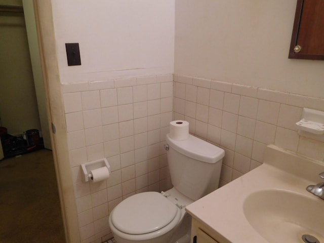 377 N Broadway Unit 601, Yonkers, NY 10701 - bathroom with tile walls, vanity, toilet, and a wainscoted wall