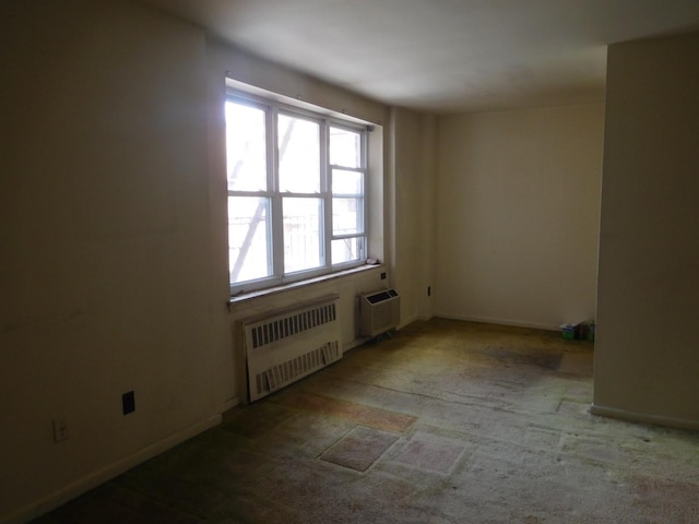 377 N Broadway Unit 601, Yonkers, NY 10701 - spare room featuring radiator, a wall mounted air conditioner, and carpet floors