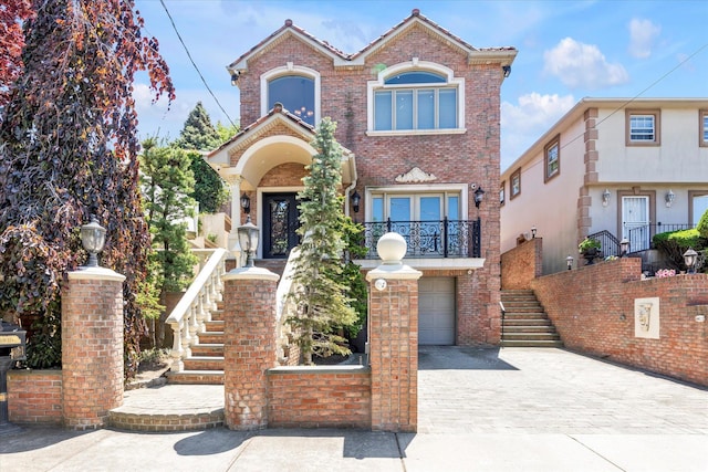 142-30 13th Ave, Malba, NY 11357 - traditional home with stairs, decorative driveway, brick siding, and a garage