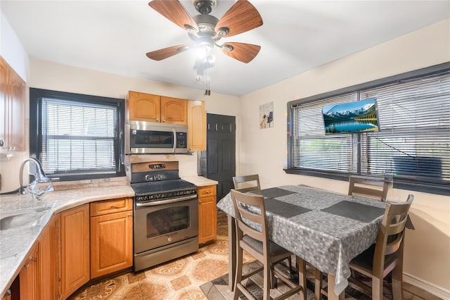 13538 129th St, South Ozone Park, NY 11420 - kitchen featuring appliances with stainless steel finishes, light countertops, and a ceiling fan