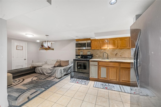13538 129th St, South Ozone Park, NY 11420 - kitchen featuring appliances with stainless steel finishes, tasteful backsplash, light tile patterned floors, light countertops, and brown cabinets