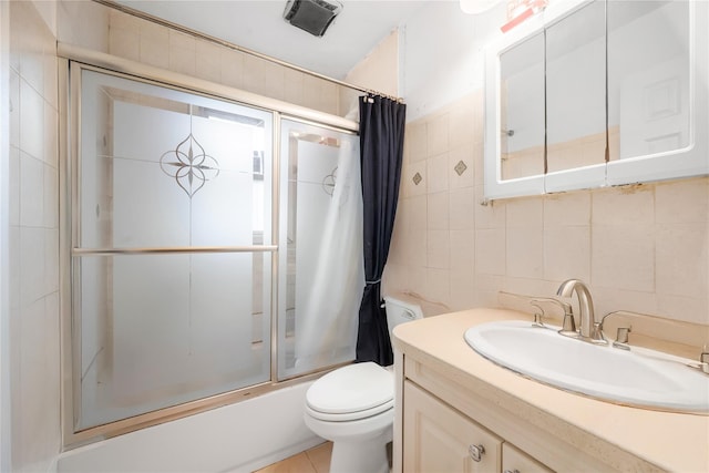 13538 129th St, South Ozone Park, NY 11420 - bathroom with tile walls, enclosed tub / shower combo, vanity, toilet, and tasteful backsplash