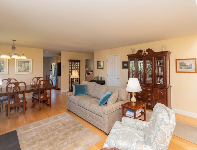 68 Hudson View Ter, Hyde Park, NY 12538 - living area with light wood finished floors, a chandelier, and baseboards