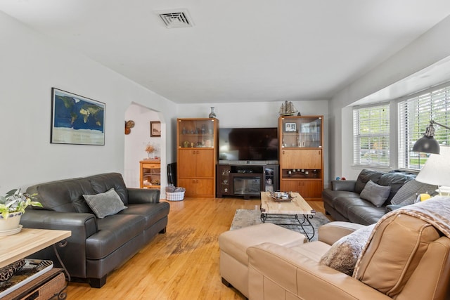 60 Heston Rd, Shirley, NY 11967 - living room featuring arched walkways and light wood-style floors